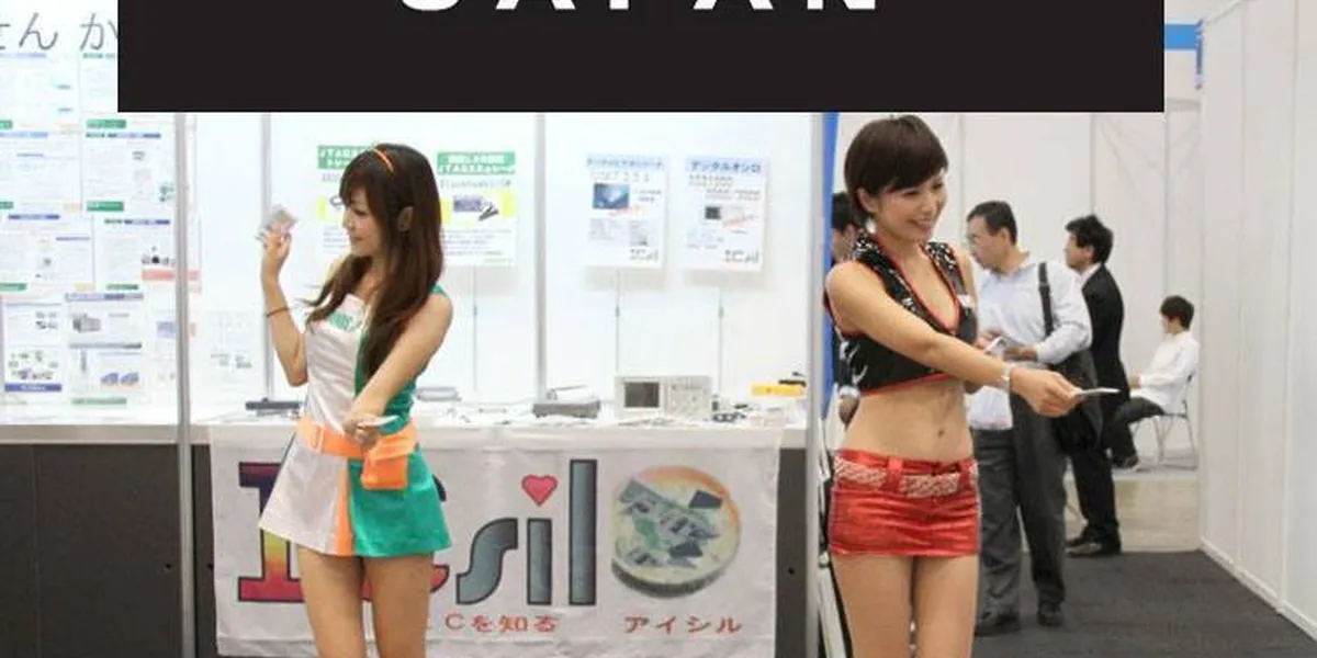 two Japanese girls handing out flyers at the Ceatec show in Japan